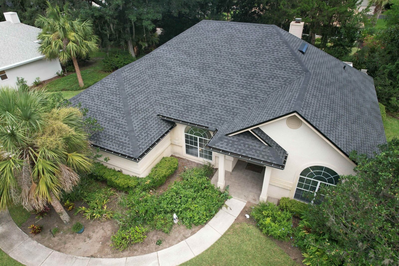 Aerial view of a gray architectural asphalt shingle roof on a Florida home