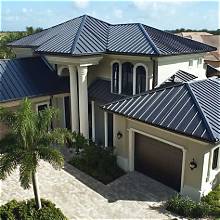 Dark standing seam metal roof on a Florida home